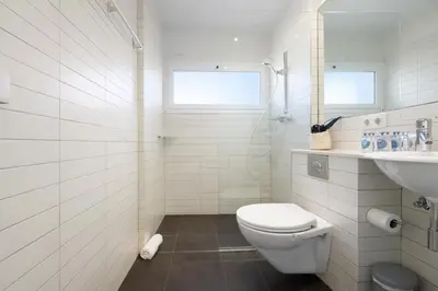 a white bathroom with a toilet and a sink at Boutique Remei in Barcelona