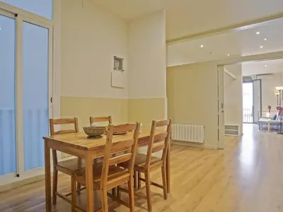 a dining room with a wooden table and chairs at Apartamento en el centro de Barcelona! in Barcelona