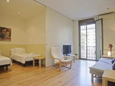 a living room with a bed and a tv at Apartamento en el centro de Barcelona! in Barcelona