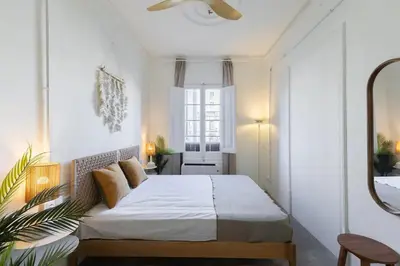 a bedroom with a bed and a mirror at ATA Five Rooms Mid term Rental in Barcelona
