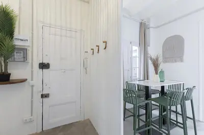 a room with a table and chairs and a door at ATA Five Rooms Mid term Rental in Barcelona