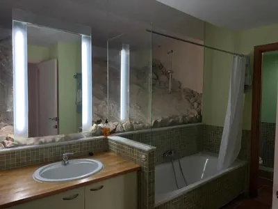 a bathroom with a sink and a shower and a tub at Casa Roca Lujo mediterráneo con piscina infinity in Sitges
