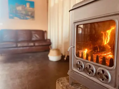 a fireplace in a living room with a couch at Masia Notari Casabona in Vilanova i la Geltrú