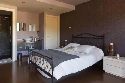 a bedroom with a large bed in a room at Espai Oliveres Barcelona Villa con piscina in Papiol