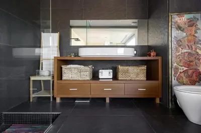 a bathroom with a vanity with a mirror and a toilet at Espai Oliveres Barcelona Villa con piscina in Papiol