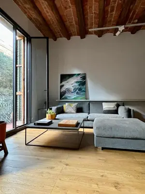 a living room with a couch and a glass table at Spacious and cozy apartment in Barcelona