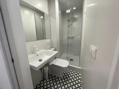 a bathroom with a toilet and a sink and a shower at NEW 2-bedroom 2-bath, 5 min walk Metro L1-FIRA BCN in Hospitalet de Llobregat