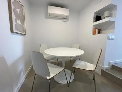 a white dining room with a white table and chairs at NEW 2-bedroom 2-bath, 5 min walk Metro L1-FIRA BCN in Hospitalet de Llobregat