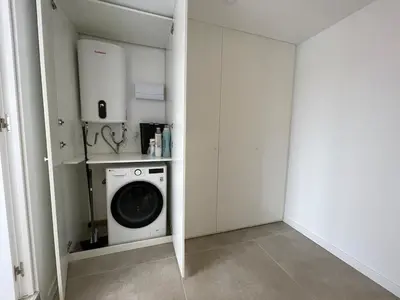 a laundry room with a washing machine in it at NEW 2-bedroom 2-bath, 5 min walk Metro L1-FIRA BCN in Hospitalet de Llobregat