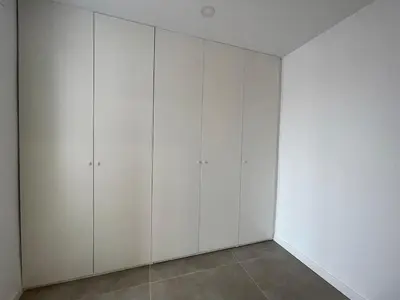 a white closet with white cabinets in a room at NEW 2-bedroom 2-bath, 5 min walk Metro L1-FIRA BCN in Hospitalet de Llobregat