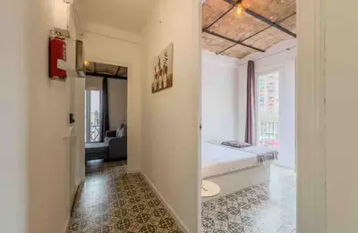 a bedroom with a bed and a living room at Apartment in BCN 2-1 in Hospitalet de Llobregat