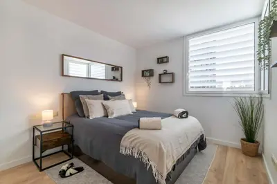 a bedroom with a large bed and a window at MODERN PENTHOUSE WITH TERRACE ON GRAN VIA DE CARLES III Andorra in Barcelona