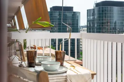 a table on a balcony with a view of a city at MODERN PENTHOUSE WITH TERRACE ON GRAN VIA DE CARLES III Andorra in Barcelona