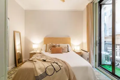 a bedroom with a large bed and a large window at BOLIVIA. NEWLY RENOVATED FULL APARTMENT WITH BRIGHT TERRACE in Barcelona