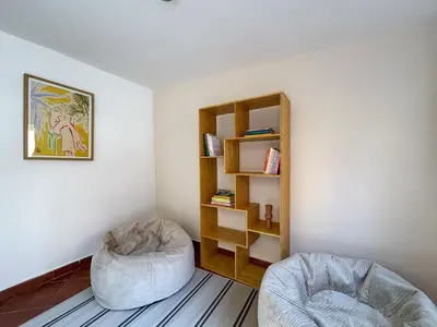 a room with two chairs and a book shelf at Stay Unique Sarrià–Sant Gervasi terraza privada in Barcelona