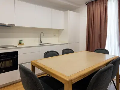 a kitchen with a wooden table and chairs at Stay U-nique Apartments Barcelona Albeniz in El Arrabal