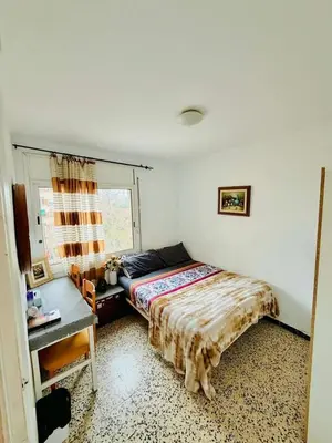 a bedroom with a bed and a desk and a window at Barcelona stay in Hospitalet de Llobregat