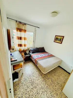 a bedroom with a bed and a desk and a window at Barcelona stay in Hospitalet de Llobregat