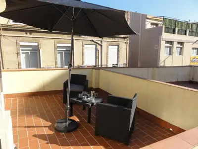 a black umbrella sitting on top of a roof at Apartamentos Barcelona - Iberia in Barcelona