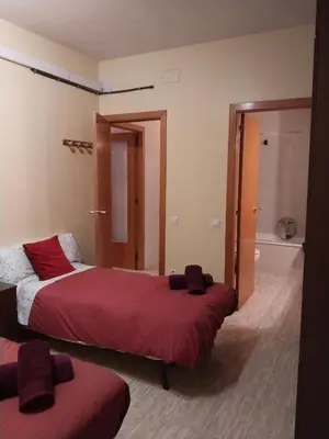 a hotel room with two beds and a bathroom at Apartament Fira in Hospitalet de Llobregat
