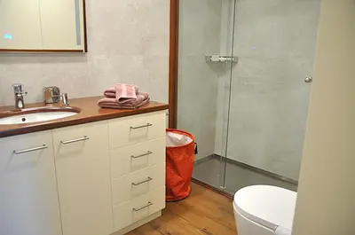 a bedroom with a large white bed and a hallway at Francesc Macià, Sitges in Sitges