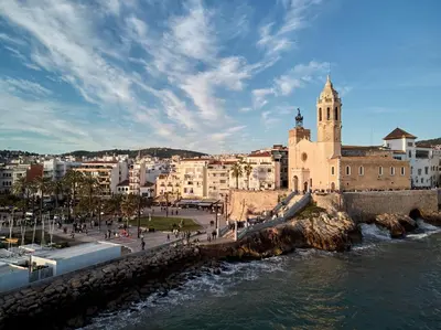 a view of a city with a river and a church at Apartamento Mallorca, muy cerca de la playa in Sitges