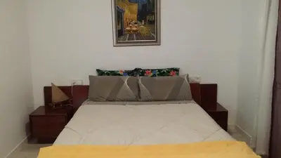a bed in a bedroom with a picture on the wall at Apartamento 2º centrico con Parking en Calella,Barcelona in Calella