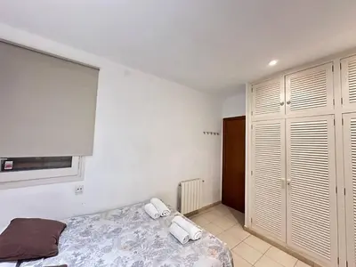 a bedroom with a bed with two towels on it at Rooms Consell de Cent in Barcelona