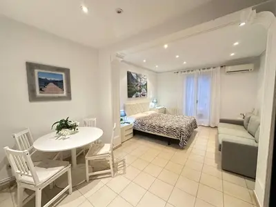 a room with a bed and a table and a couch at Rooms Consell de Cent in Barcelona