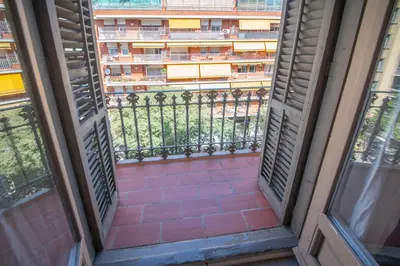 an open window with a view of a building at You Stylish Eixample Apartments in Barcelona