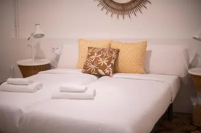 a white bed with pillows on it in a room at You Stylish Eixample Apartments in Barcelona