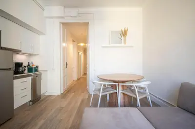 a small kitchen with a table and chairs in a room at You Stylish Eixample Apartments in Barcelona