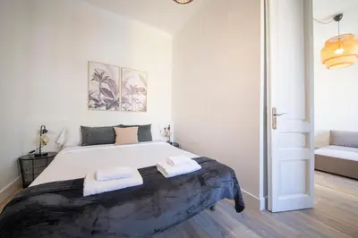 a bedroom with a large bed with two towels on it at You Stylish Eixample Apartments in Barcelona