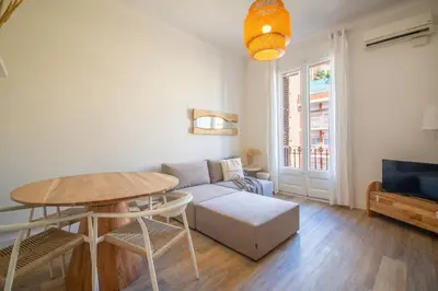 a living room with a table and a couch at You Stylish Eixample Apartments in Barcelona