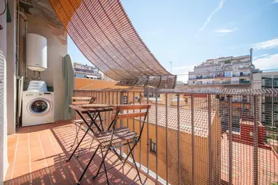 a balcony with a table and a washing machine at You Stylish Eixample Apartments in Barcelona