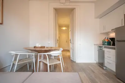 a kitchen with a table and chairs in a room at You Stylish Eixample Apartments in Barcelona