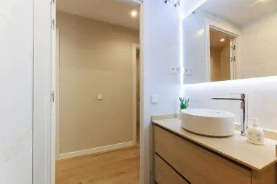 a bathroom with a sink and a mirror at ApartEasy mid-term ONLY for VACATIONS stays, EIXAMPLE CENTER in Barcelona