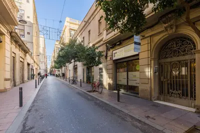 an empty street in a city with buildings at ApartEasy mid-term ONLY for VACATIONS stays, ATIC GRACIA in Barcelona