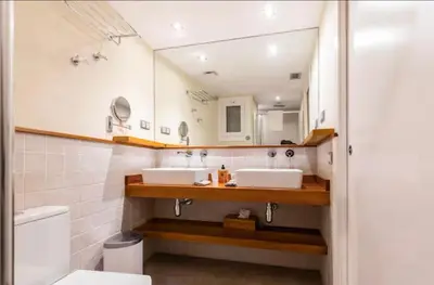 a bathroom with two sinks and a mirror at Little Dream Apartment Sitges in Sitges