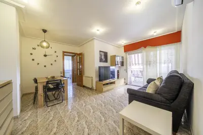 a living room with a couch and a table at HomeHolidaysRentals Coquette - Costa Barcelona in Pineda de Mar