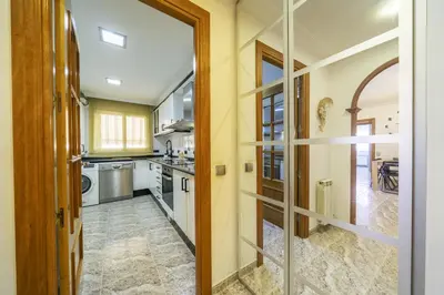 a kitchen with a door leading to a dining room at HomeHolidaysRentals Coquette - Costa Barcelona in Pineda de Mar