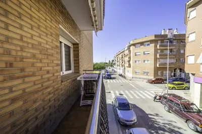 a balcony with cars parked on the side of a building at HomeHolidaysRentals Coquette - Costa Barcelona in Pineda de Mar