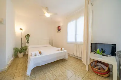 a white bathroom with a toilet and a sink at HomeHolidaysRentals Olimpia - Costa Barcelona in Pineda de Mar