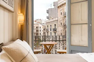 a bedroom with a bed and a view of a city at Lovely Apartment with Balcony in Sagrada Familia in Barcelona