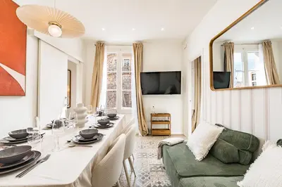 a dining room with a table and a couch at Lovely Apartment with Balcony in Sagrada Familia in Barcelona