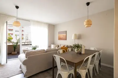 a living room with a table and a couch at Eixample Barcelona Luxury for 8 in Barcelona