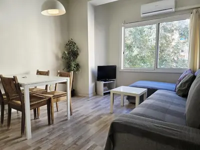 a bedroom with a large bed with a window at little 3 bedrooms apartement barcelona center in Barcelona
