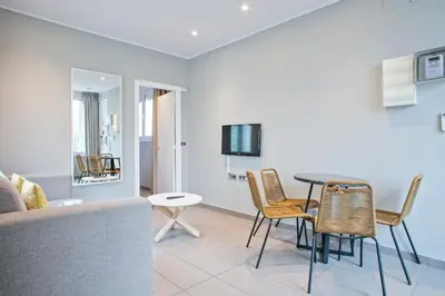 a living room with a table and chairs and a couch at Alcam Entenza in Barcelona