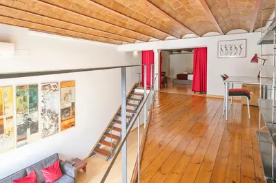 an open living room with a wooden ceiling at Alcam Paseo de Gracia in Barcelona