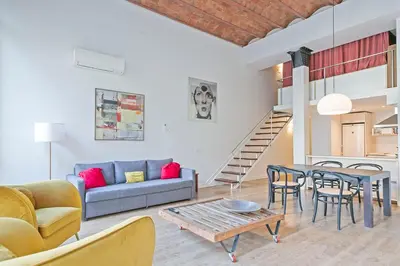 a living room with a couch and a table at Alcam Paseo de Gracia in Barcelona